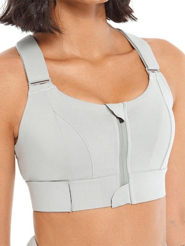 Stylish women's shockproof sports bra with adjustable fastening in light gray, offering comfort and support for fitness activities.